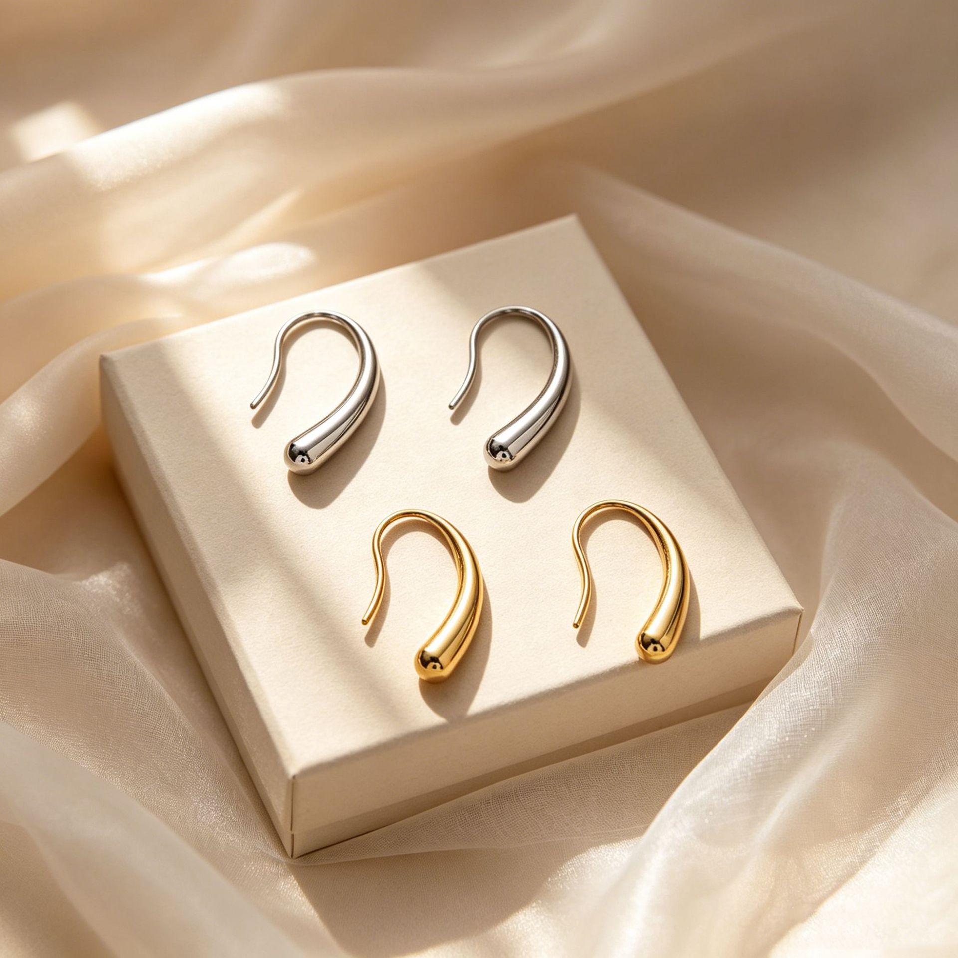 Cross-border best-selling light-luxury small droplet titanium steel earrings for women—exquisite, vintage, high-end vibe, with a curved hook design, in a minimalist style.