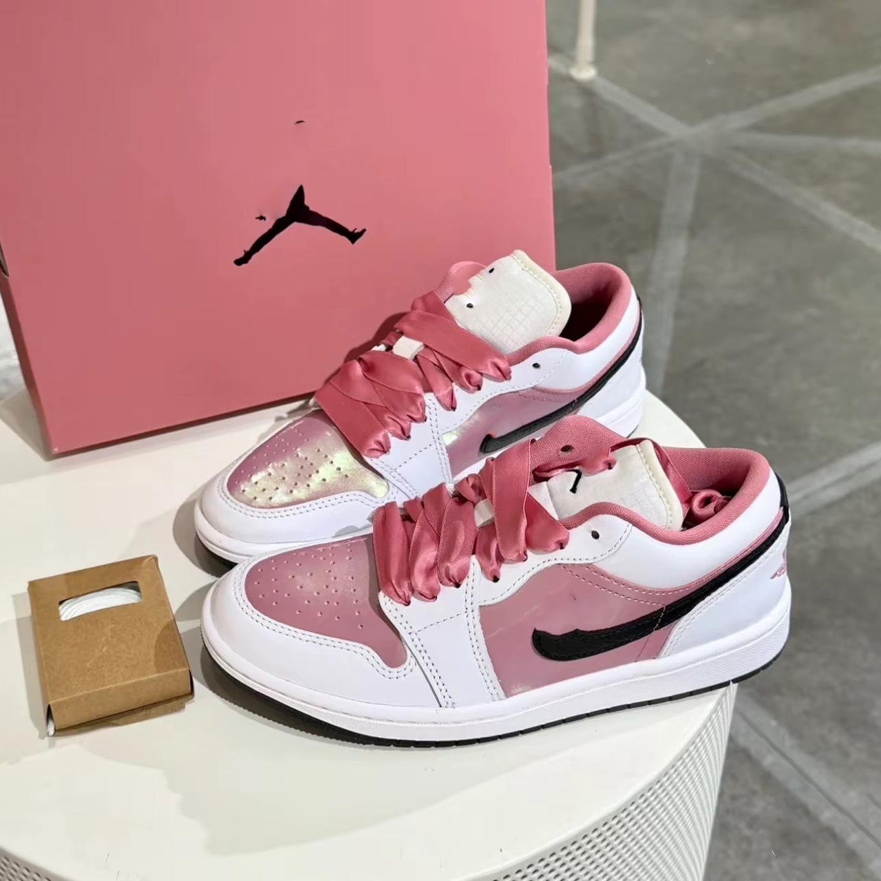 AJ 1 low‑top sneakers with gradient pearlescent laser pink finish, featuring tassels—new Chinese‑style JORDAN 1 campus retro casual shoes