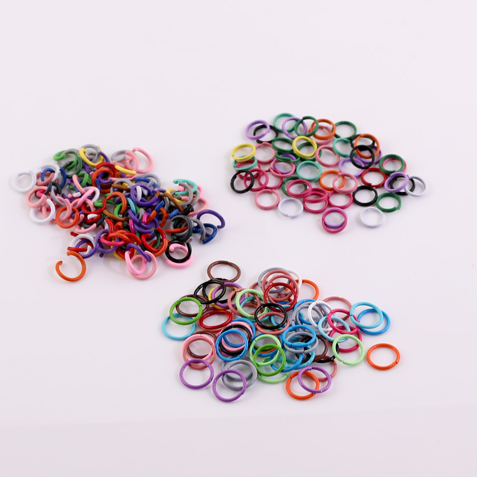 Various colored baked‑on paint single‑loop, double‑loop, and open‑loop DIY doll pendants, keychains, and decorative accessories—materials and components.