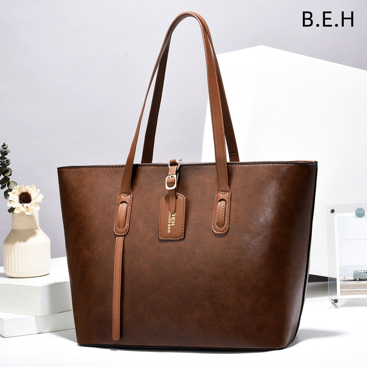 Kobe Leather Tote Bag – Taizhou Women’s Bags. A single-shoulder, diagonal-style bag with a comfortable tote handle. It’s a stylish and practical bag for carrying items around. BEHtotebags